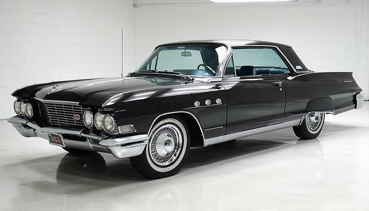 A gleaming 1963 Buick Riviera in a showroom setting, showcasing its sleek design and powerful presence