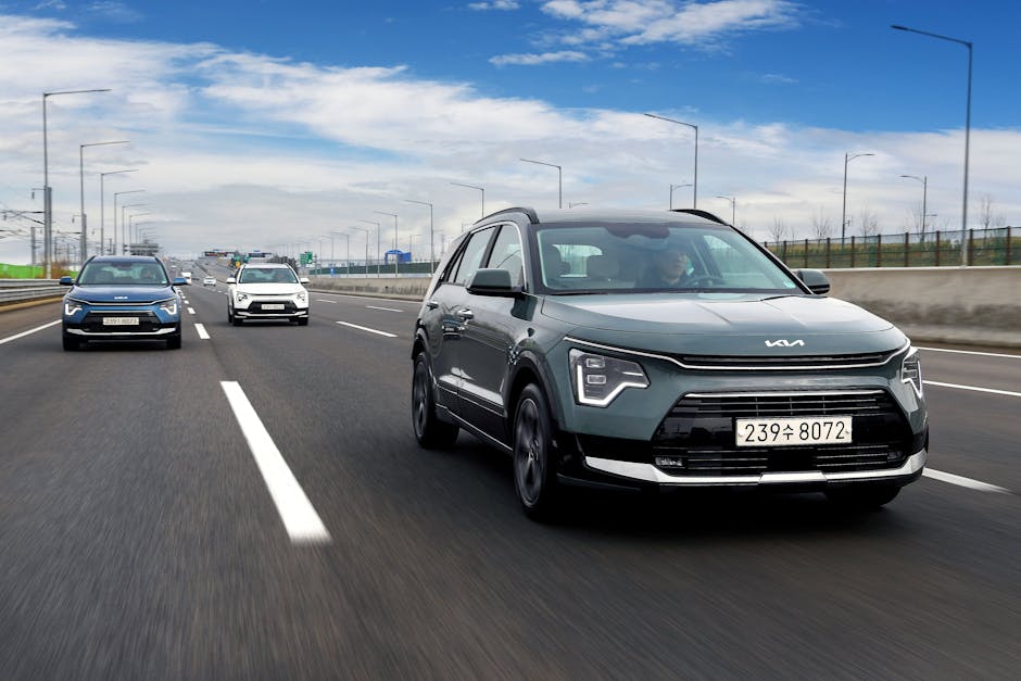 A sleek Kia Niro hybrid SUV driving on a highway