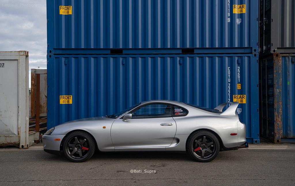 Side profile of a 1994 Toyota Supra MK4, showcasing its sleek aerodynamic design and iconic rear spoiler